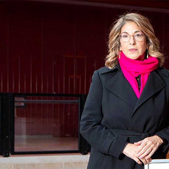 head and shoulders portrait of a woman in a bright scarf
