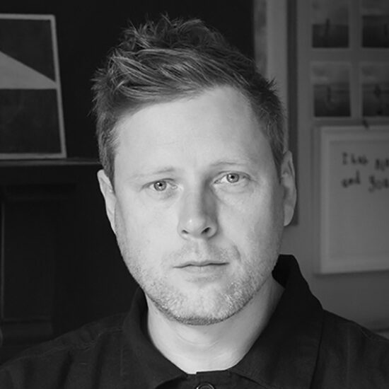 head and shoulders portrait of a man in a black shirt